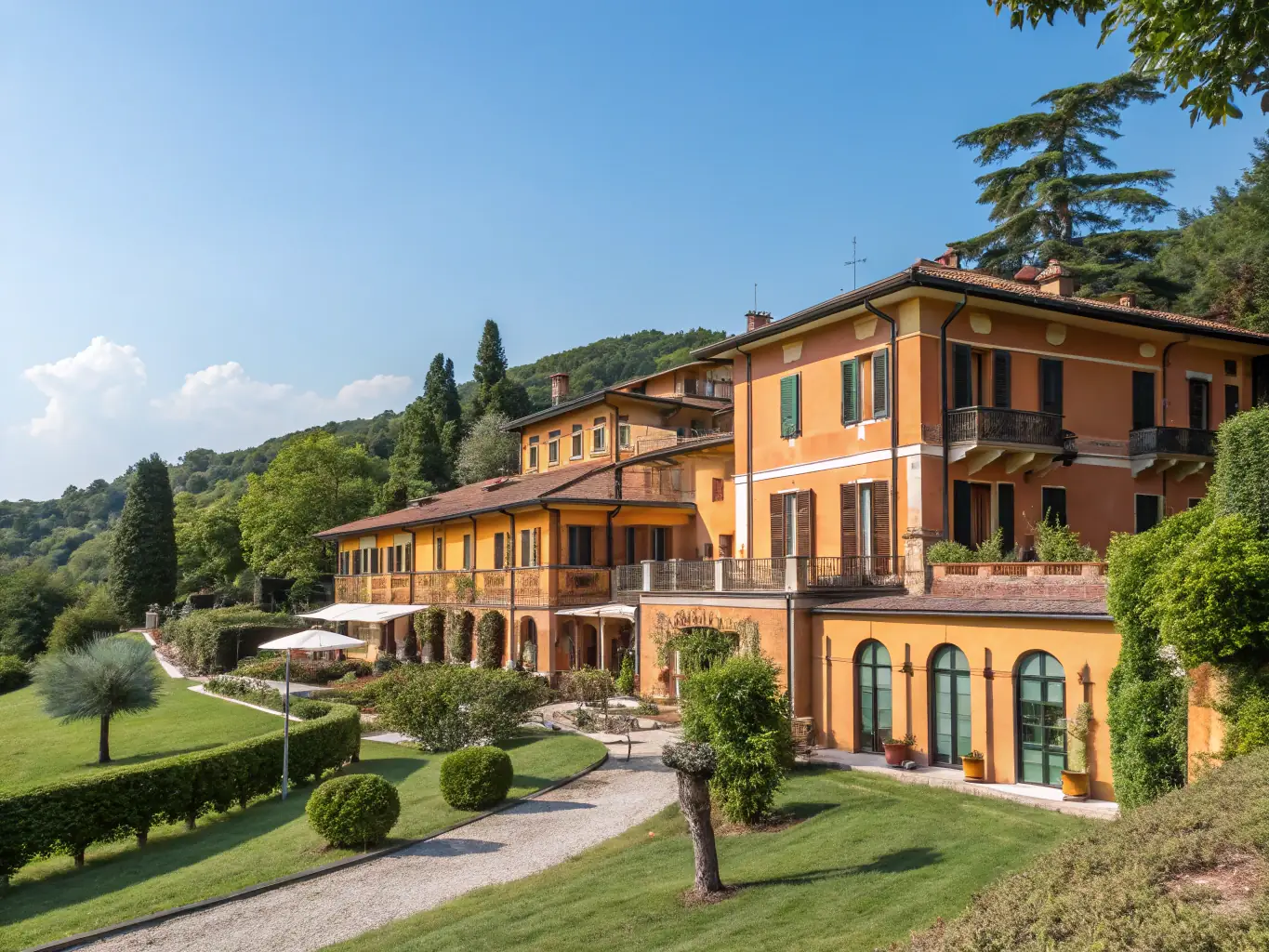 An exterior shot of Le Sirenuse in Positano, Italy, capturing its iconic architecture, vibrant bougainvillea, and stunning views of the Amalfi Coast.